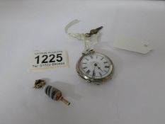 A ladies silver fob watch with key and a gold mounted watch key