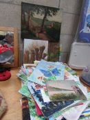 A large quantity of unframed paintings