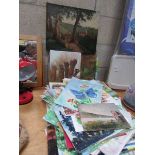 A large quantity of unframed paintings