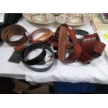 A quantity of leather belts and a leather purse