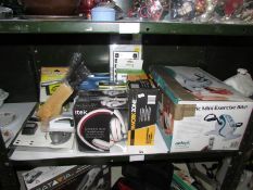 A shelf of miscellaneous including head phones,