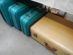 A vintage suitcase and a set of 3 suitcases