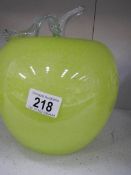 A large green glass apple