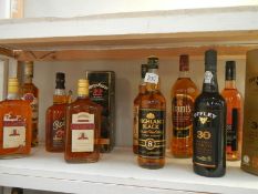 A quantity of bottles of alcohol including whisky