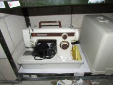A cased Frister and Rossman sewing machine