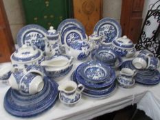 A mixed lot of blue and white willow pattern dinner ware