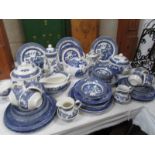 A mixed lot of blue and white willow pattern dinner ware