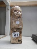 An art pottery swaddling baby,