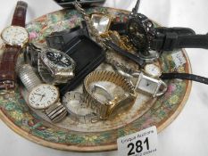 A quantity of wrist watches on an oriental plate