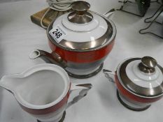 A 3 piece porcelain and silver tea set