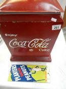 A replica coca-cola ice box and a Planters peanut sign