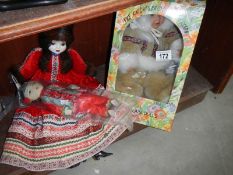 A boxed doll and 2 others