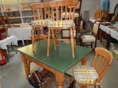 A pine dining table and 4 chairs