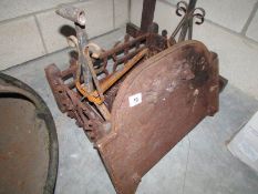 A Victorian iron dog grate with fire back and dogs