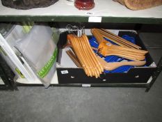 A quantity of linen and wooden coat hangers