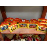 A collection of 13 Rupert the Bear die-cast cars and models in boxes