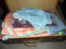 A vintage suitcase containing linen