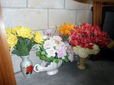 A quantity of vases containing artificial flowers