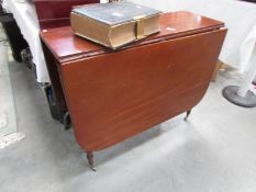 A mahogany drop leaf table