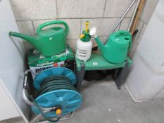 A quantity of garden items including hose pipe,