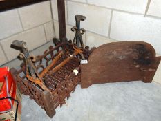 A cast iron dog grate with fire back