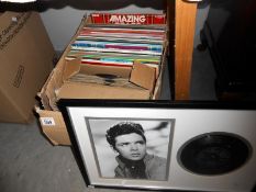 A Cliff Richard presentation disc and a box of 78 rpm records