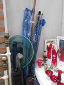 A quantity of fishing rods and poles etc