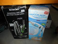 A Silver Crest vacuum cleaner and a Vapour mop x1000 hand held floor steamer