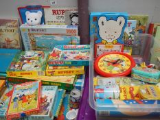 A collection of Rupert the Bear collectibles, jigsaws,