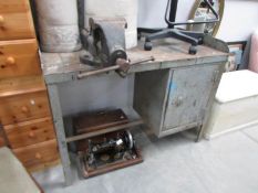 A metal work bench with attached vice