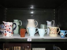 A mixed lot of jugs etc, one shelf