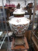 A gilt and ceramic lidded urn