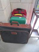 2 suitcases and a portfolio case