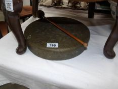 A brass gong with hammer but no stand