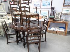 An oak gate leg table with 2 carvers and 4 dining chairs