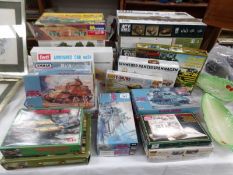 A collection of 28 boxed model kits of tanks and military vehicles