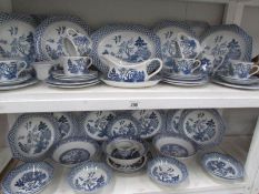 2 shelves of blue and white tea and dinner ware