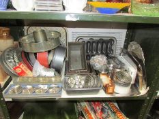 A shelf of assorted baking tins etc