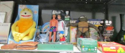 A shelf of assorted toys including Robot