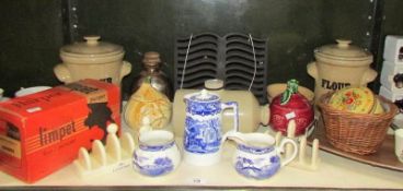 A shelf of miscellaneous items including storage jars,