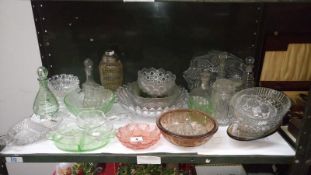 A shelf of mixed glass ware