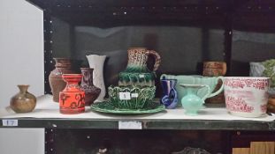 A shelf of miscellaneous pottery etc