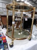 A brass framed tea trolley with glass tray