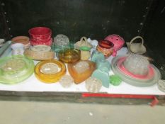 A shelf of glass flower holders etc