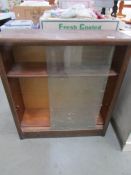 A glazed sliding door book case