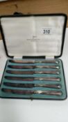 A cased set of butter knives