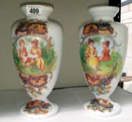 A pair of hand decorated white glass vases