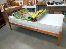 A pine single bed with mattress