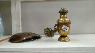 A brass boat gimbal lamp on a copper coaching warmer