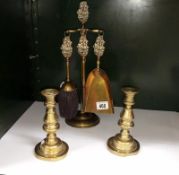 A brass fire iron set and a pair of candlesticks